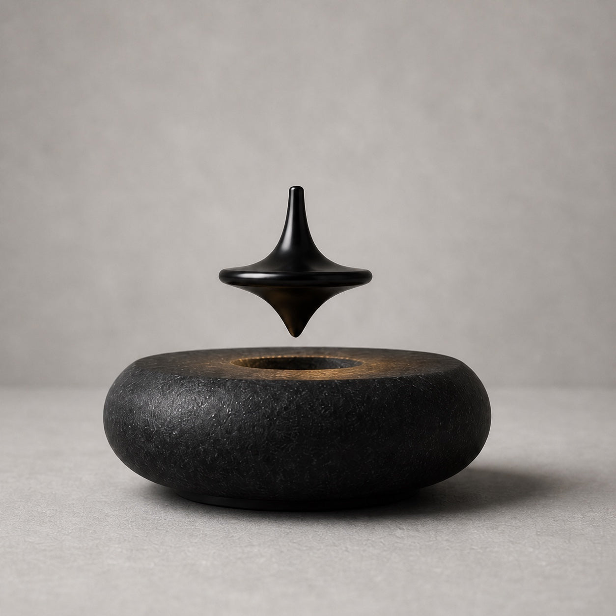 Hoverstone Orbit Top floating above a black stone base